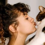 Cat licks my eyebrows while I lie down